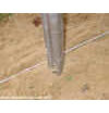 Tension wire is stretched on the same side of the line/ intermediate posts as the chain link fabric. This will 'sandwich' the tension wire in-between the chain link and posts.